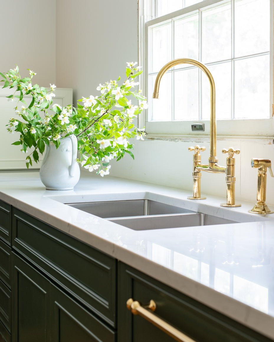 Unlacquered brass kitchen faucet with straight legs and gooseneck spout - Studio View